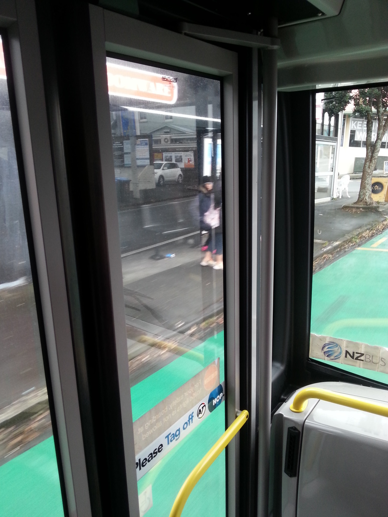 A bus driving past waiting passengers